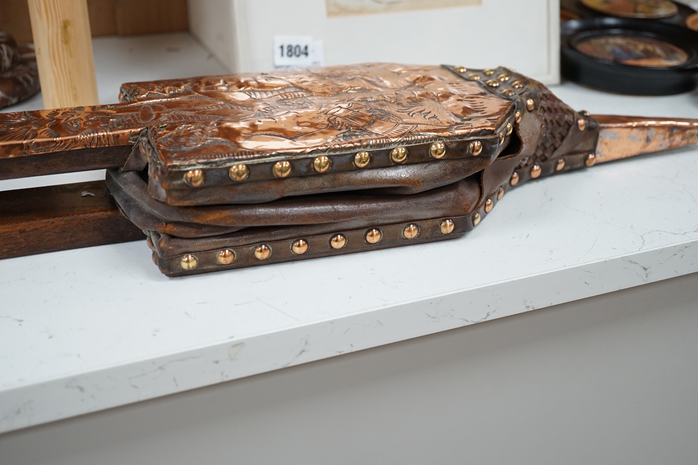 A pair of early 20th century copper bellows embossed with fauns, 81cm in length. Condition - fair